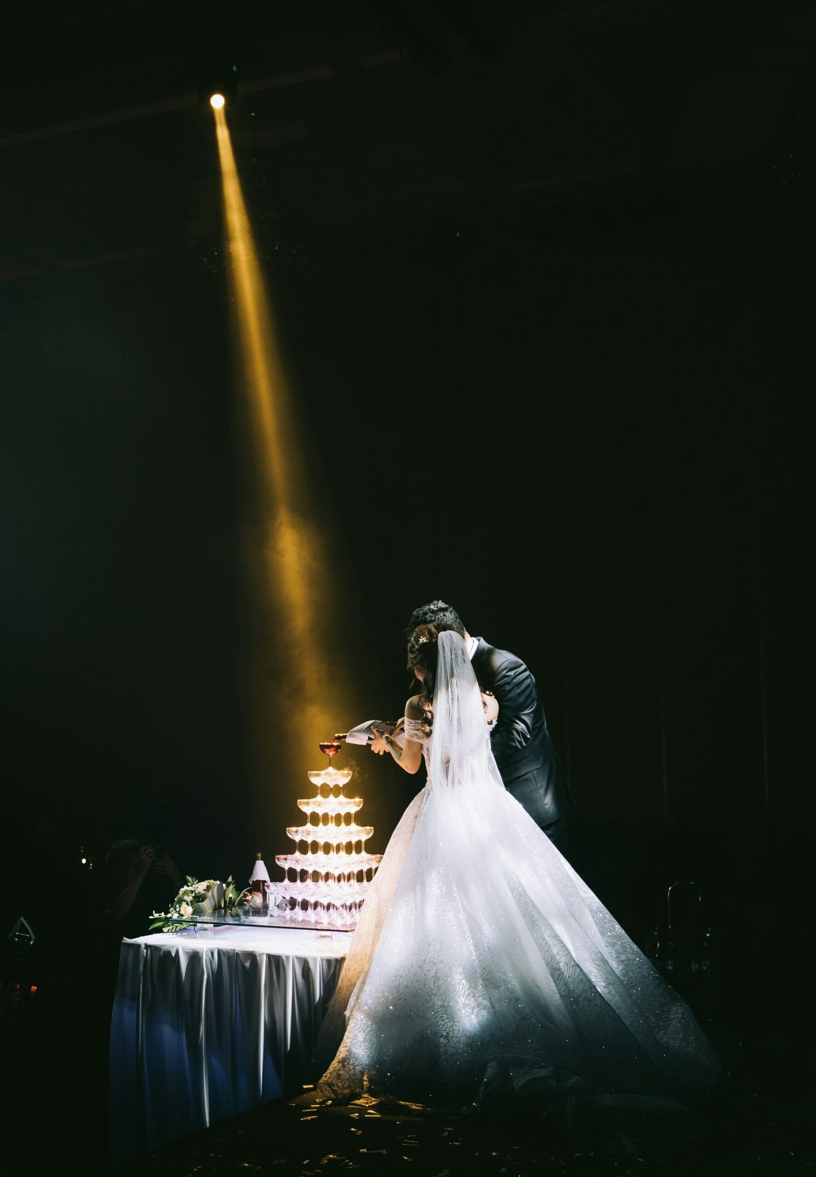 Wedding couple celebrating with a champagne tower during their destination wedding in Barcelona, toasting to a love filled with joy and elegance.